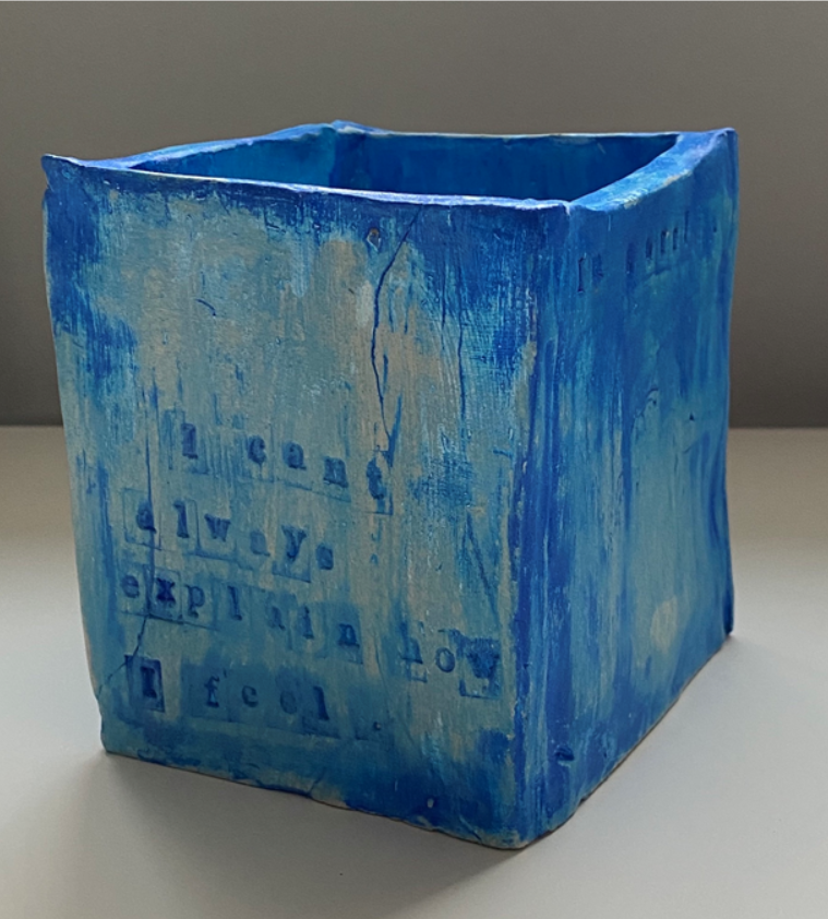 A square pot - pottery that is stamped with words. Shades of blue.

Art for mental health/ art and mental health.