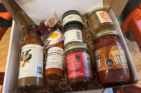 Holiday box filled with sauces and coupons from the Dane County Health Collective